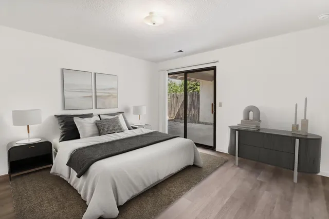 a bedroom with a bed and a table