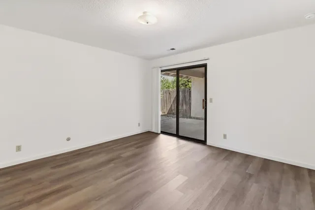 an empty room with wooden floor and closet