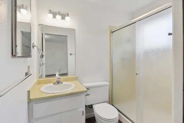a bathroom with a sink toilet and shower