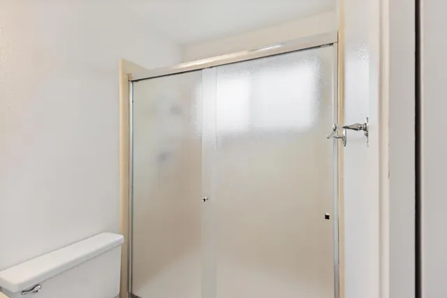a bathroom with a glass shower door