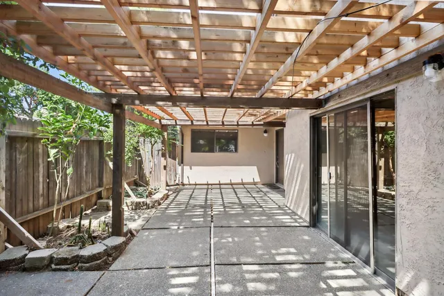 a view of a porch with a wooden fence