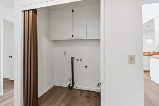 a view of a room with wooden floor