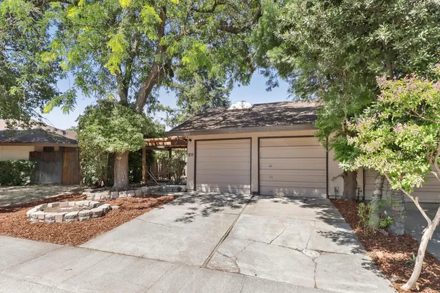 a view of a house with a yard and tree