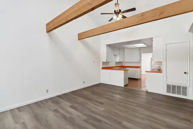 a view of a kitchen with wooden floor and a kitchen
