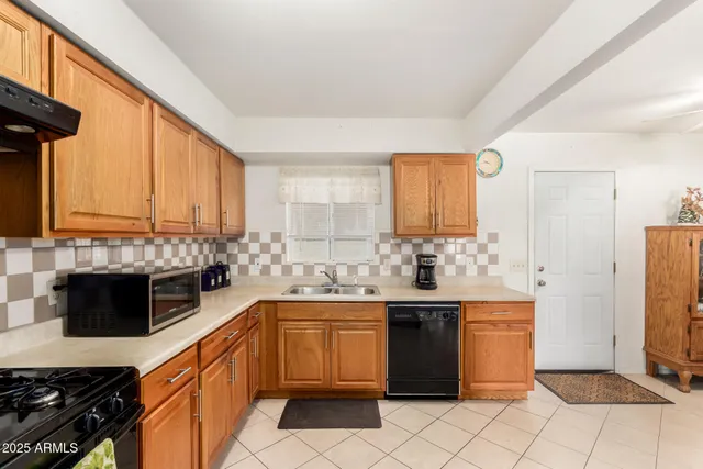 a kitchen with a sink stove and refrigerator
