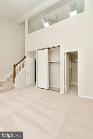 a view of an empty room with closet