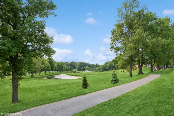 a view of a park with trees and a lake