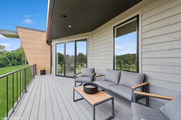 a balcony with furniture and wooden floor