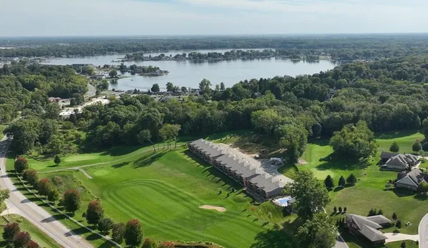 an aerial view of a houses with outdoor space and lake view