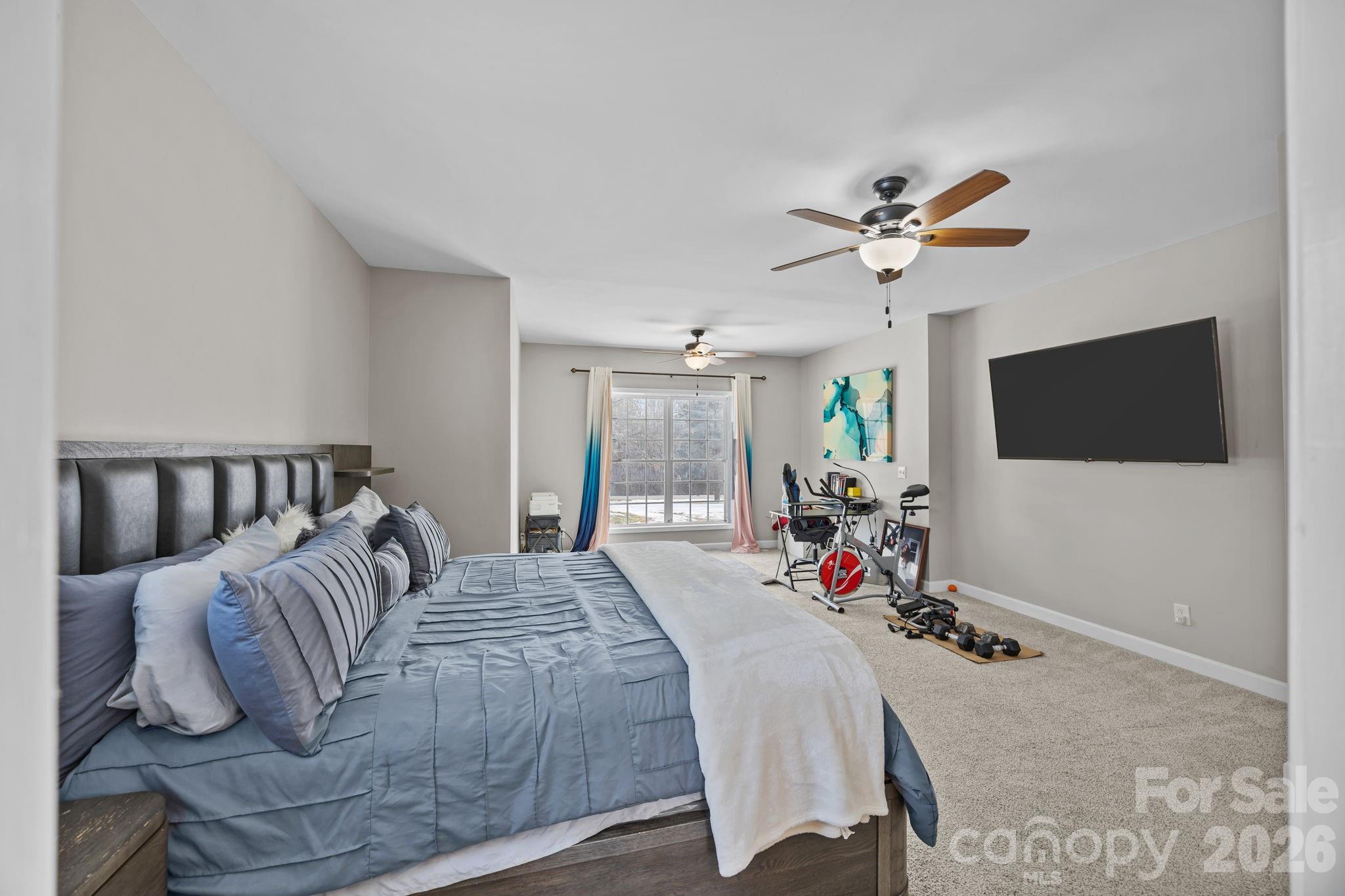 4275 Bethany Church Road Claremont, NC 28610 - Photo 16 of 39 a bed room with a bed a television and a fireplace