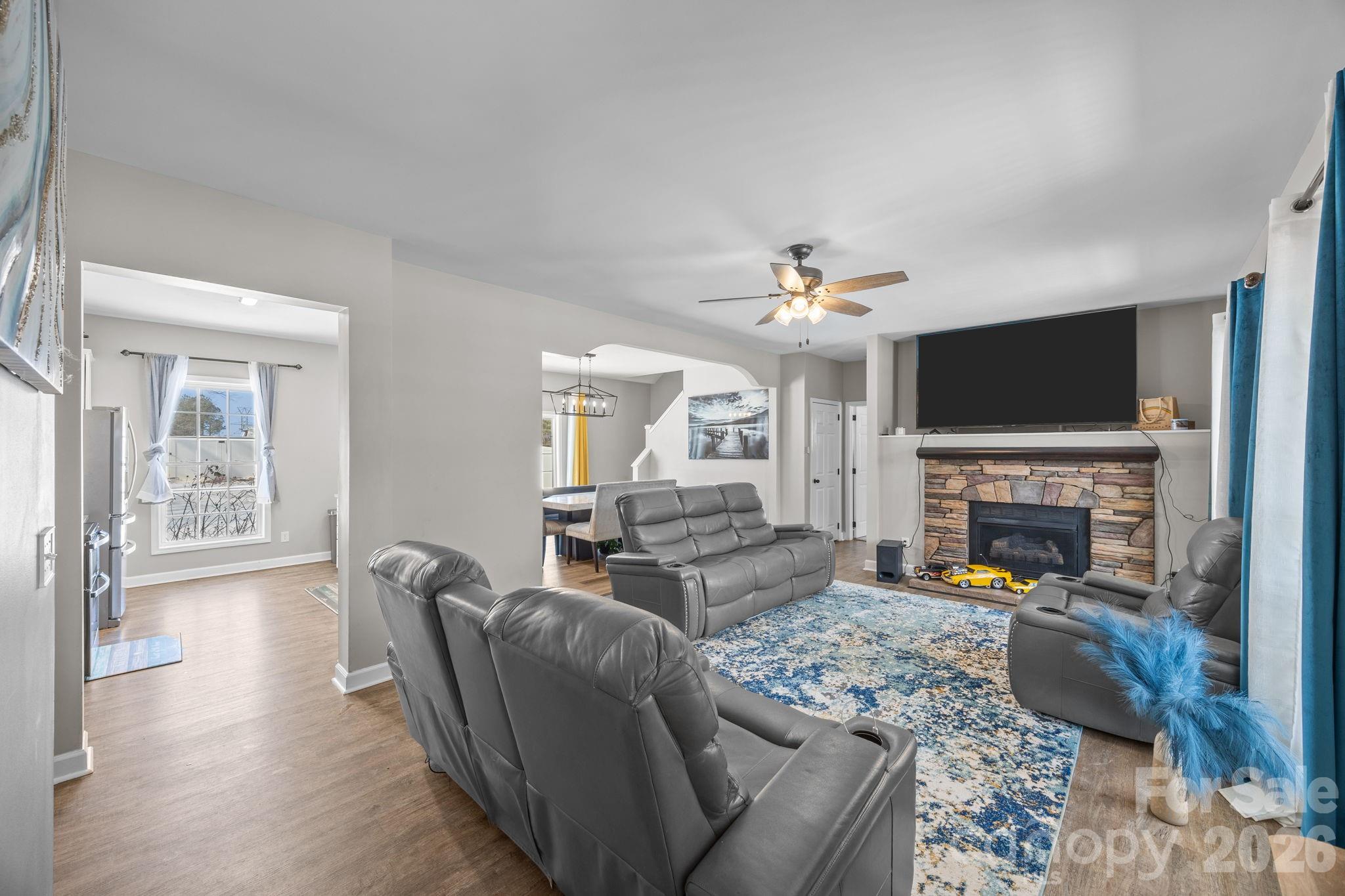 4275 Bethany Church Road Claremont, NC 28610 - Photo 19 of 39 a living room with furniture a fireplace and a flat screen tv