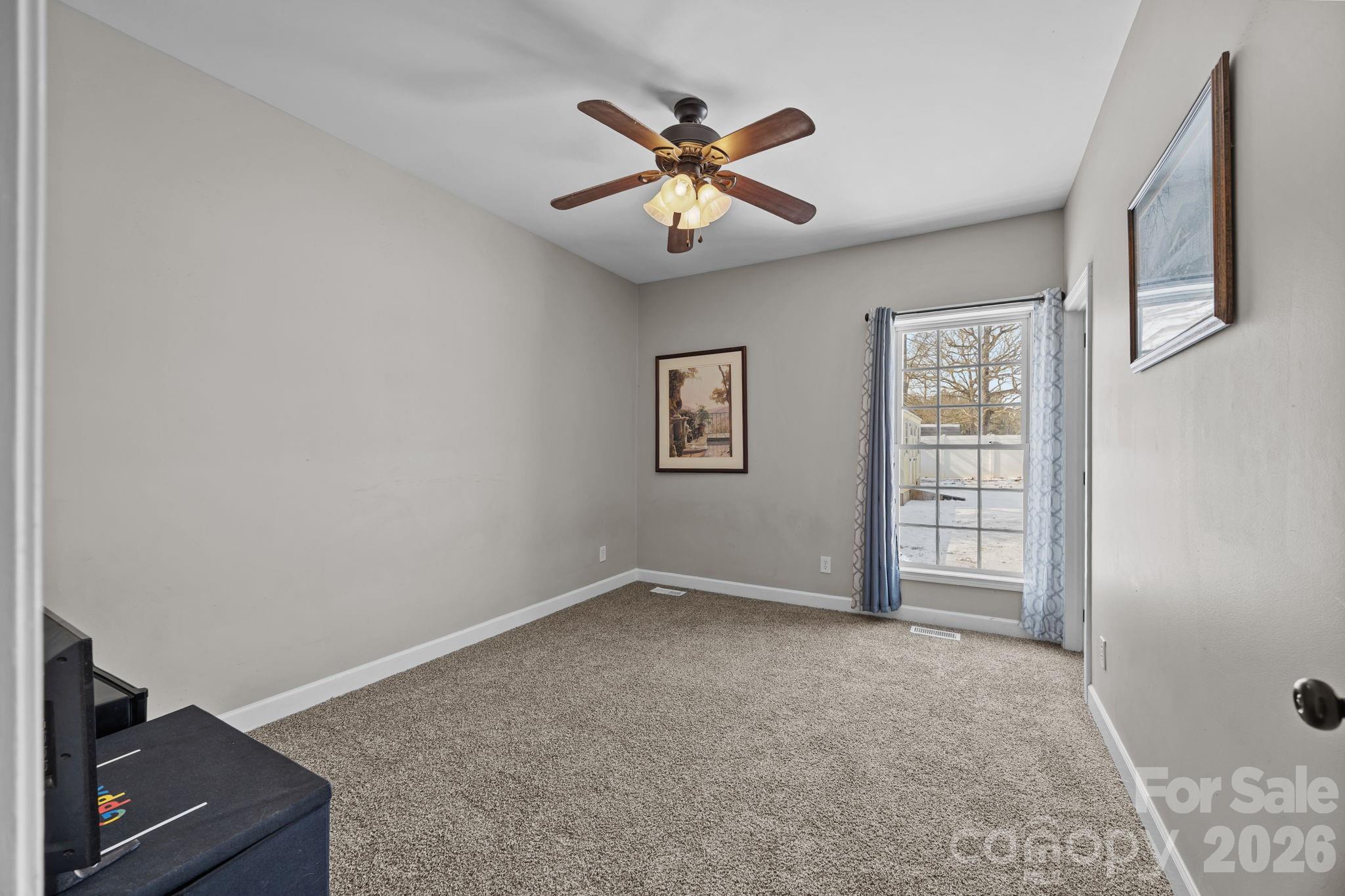 4275 Bethany Church Road Claremont, NC 28610 - Photo 22 of 39 an empty room with windows and fan