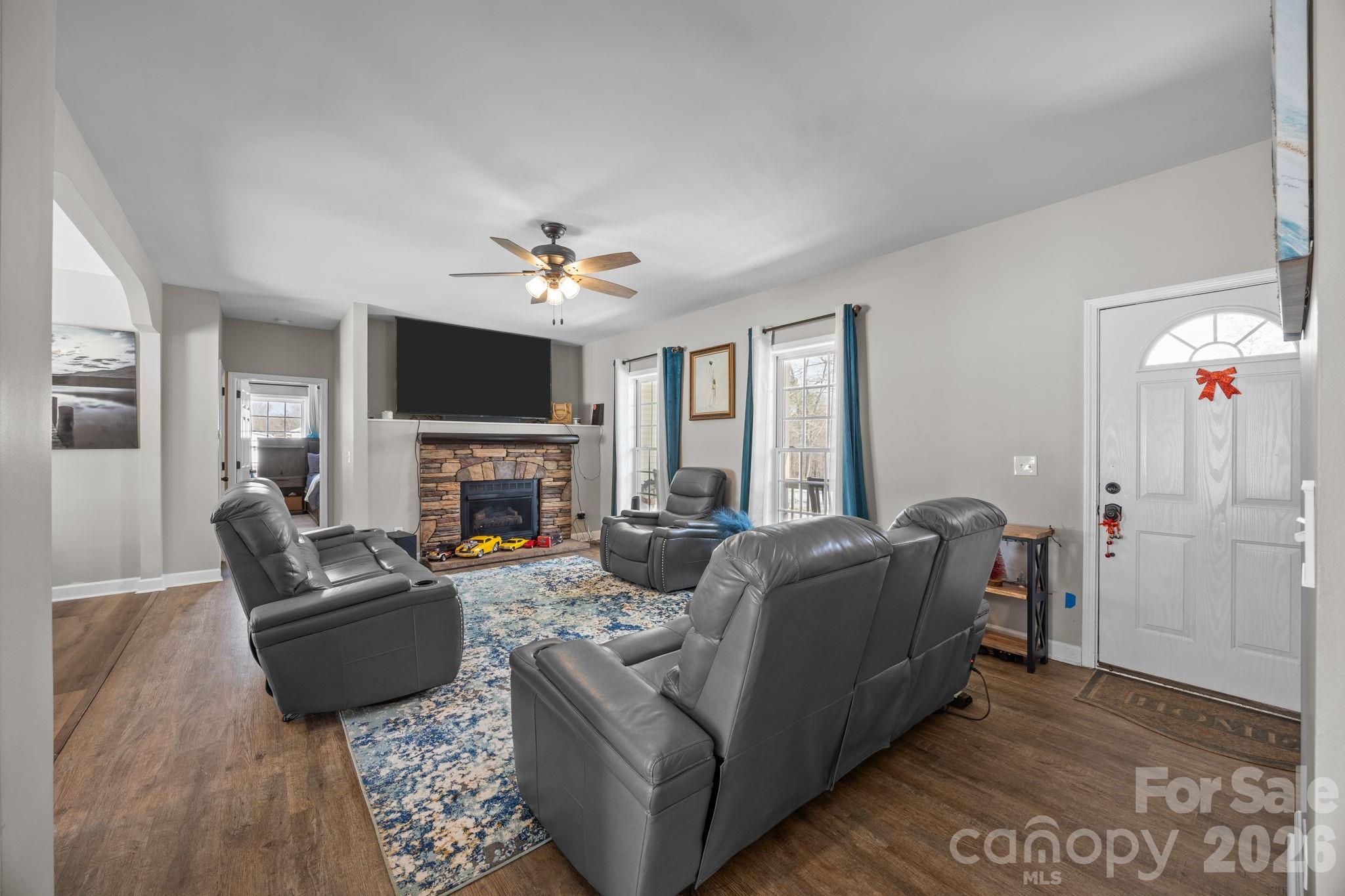 4275 Bethany Church Road Claremont, NC 28610 - Photo 33 of 39 a living room with furniture a fireplace and a flat screen tv