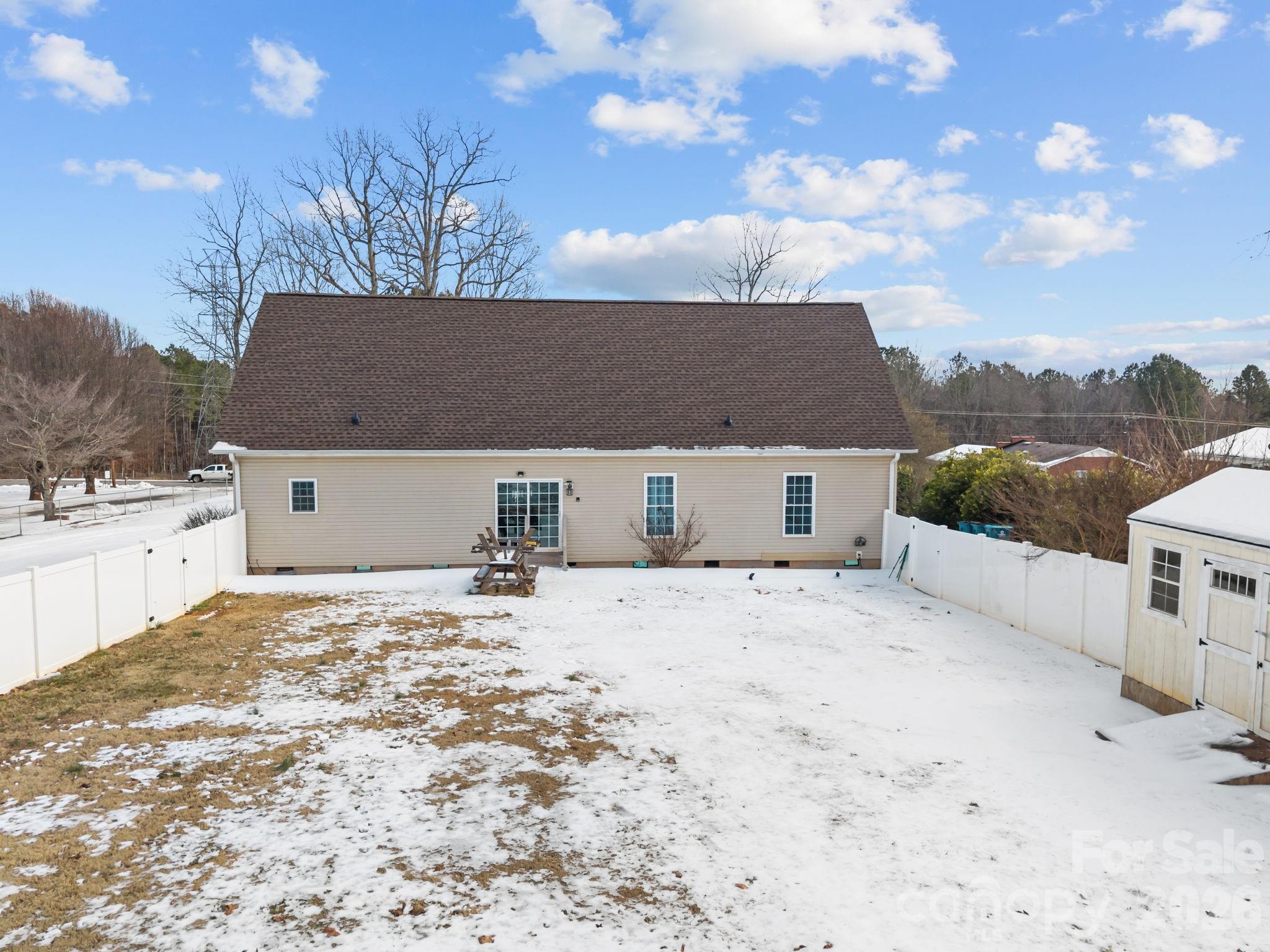 4275 Bethany Church Road Claremont, NC 28610 - Photo 36 of 39 a front view of a house with a yard covered with snow in front of house