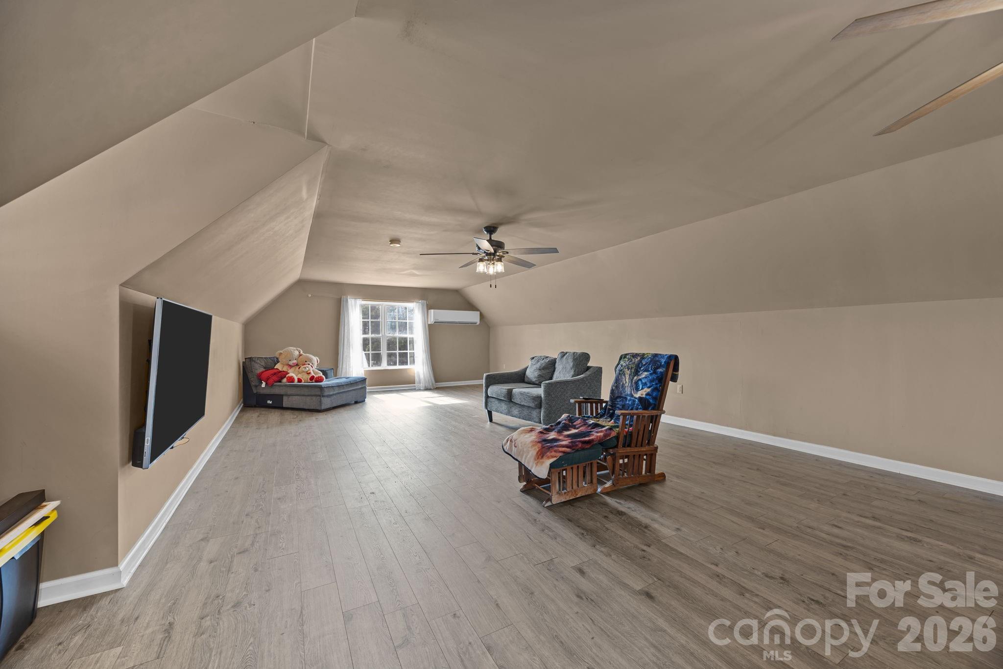 4275 Bethany Church Road Claremont, NC 28610 - Photo 8 of 39 a view of a livingroom with furniture a ceiling fan and wooden floor