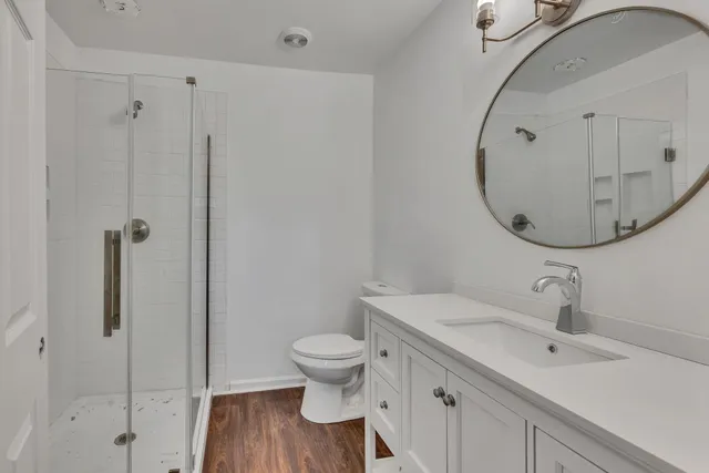 a bathroom with a sink a toilet and a mirror