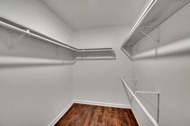 a view of walk in closet with empty racks
