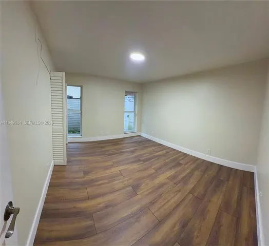 a view of an empty room and wooden floor