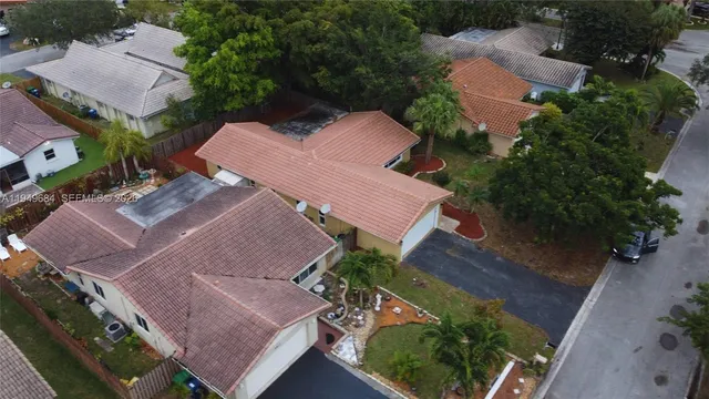 an aerial view of a house with a yard