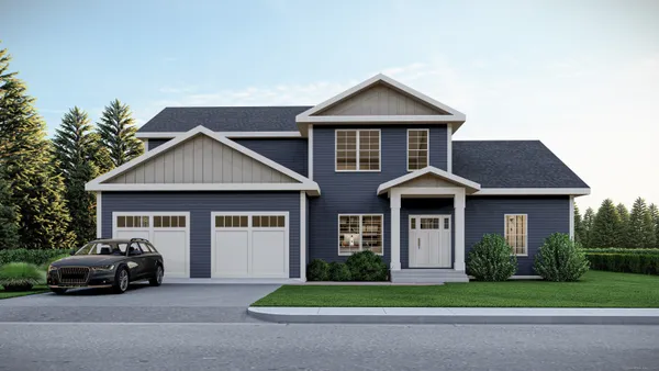 a car parked in front of a house with a small yard