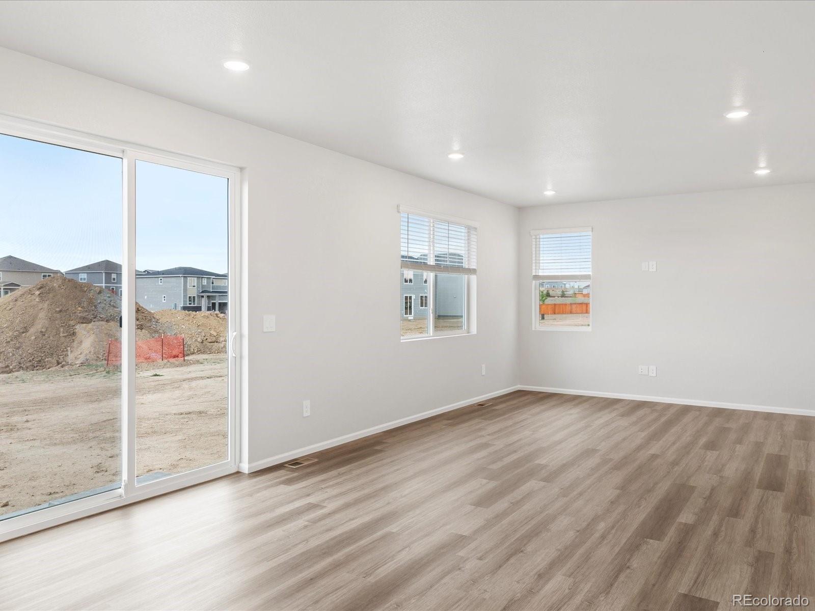 7331 West 27th Street Greeley, CO 80634 - Photo 11 of 40 an empty room with wooden floor and windows