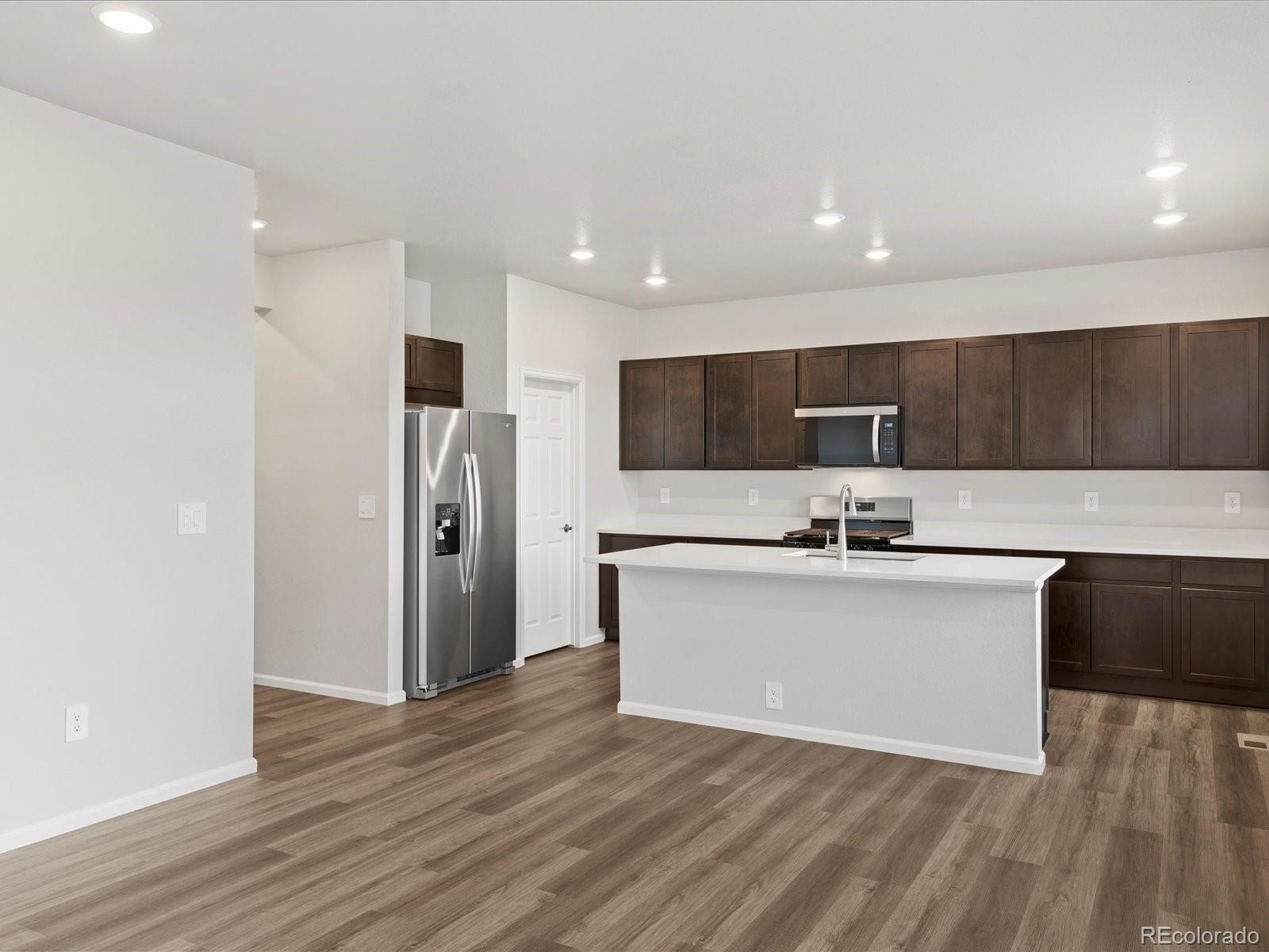 7331 West 27th Street Greeley, CO 80634 - Photo 13 of 40 a kitchen with stainless steel appliances a refrigerator sink and microwave
