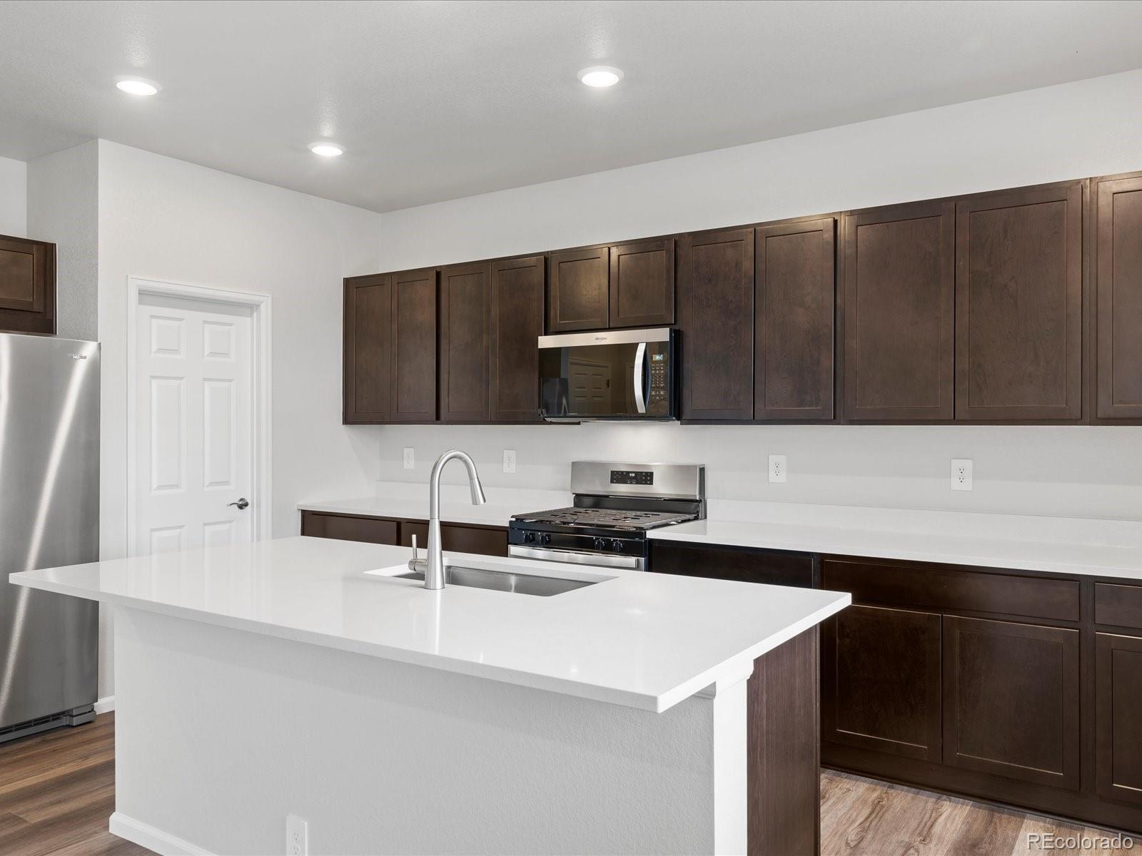 7331 West 27th Street Greeley, CO 80634 - Photo 14 of 40 a kitchen with a sink and a refrigerator