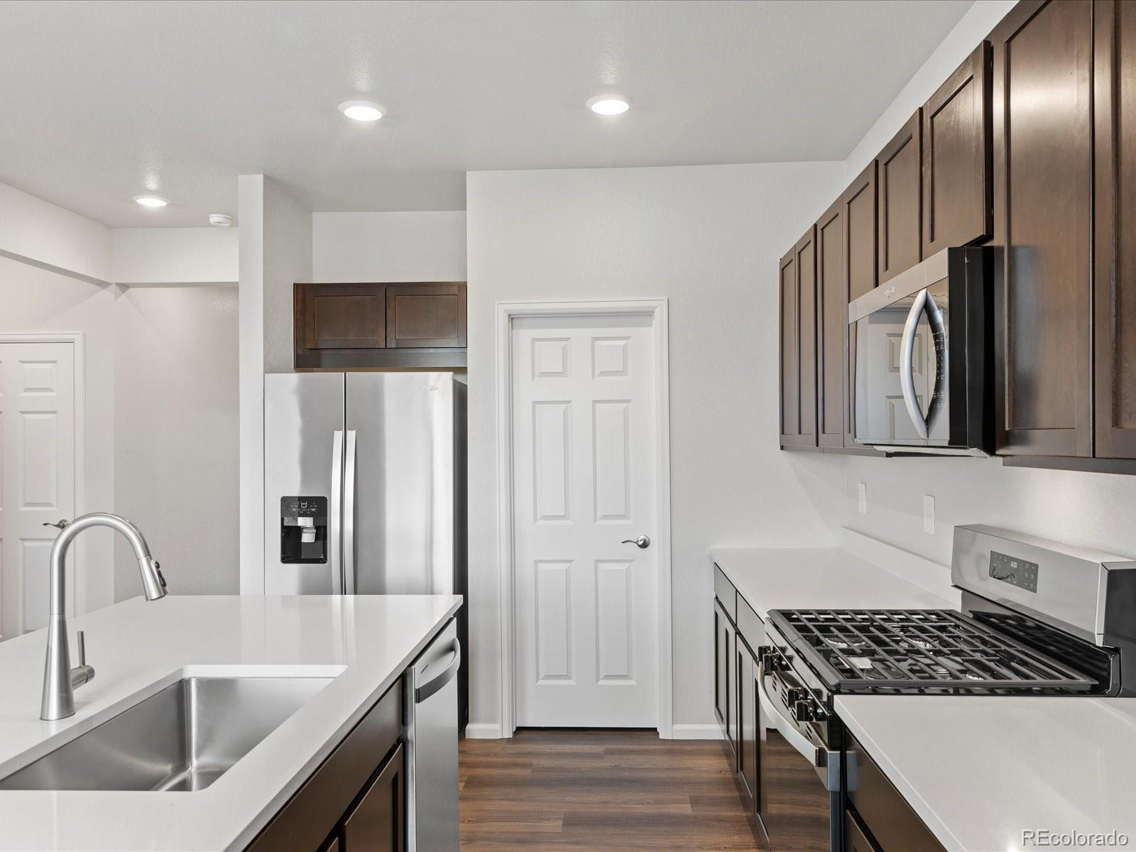7331 West 27th Street Greeley, CO 80634 - Photo 15 of 40 a kitchen with stainless steel appliances granite countertop a sink stove and refrigerator