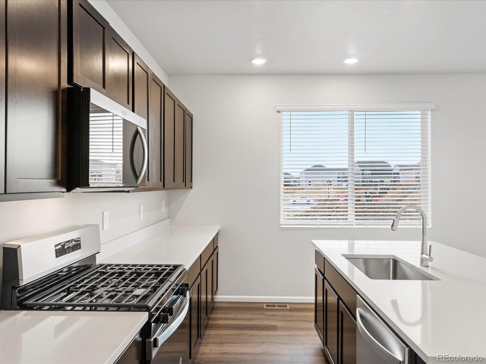 7331 West 27th Street Greeley, CO 80634 - Photo 17 of 40 a kitchen that has a sink and a stove