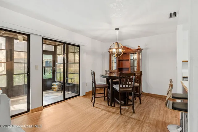 a dining room with furniture window and wooden floor