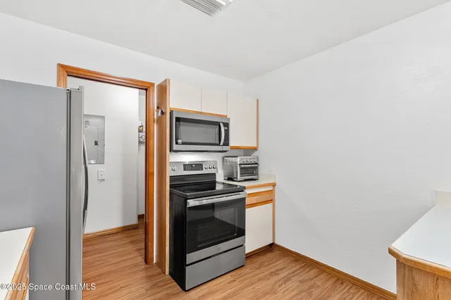 a kitchen with a stove and a microwave