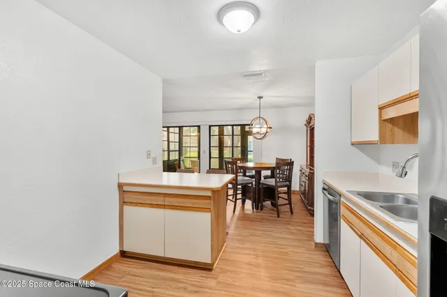 a view of a kitchen with dining room and wooden floor