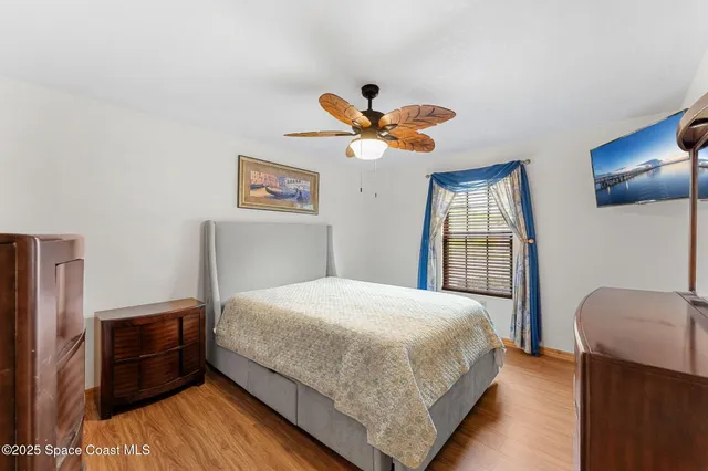 a bedroom with a bed and a large mirror