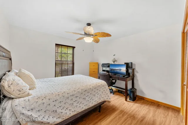 a bedroom with a bed and a desk