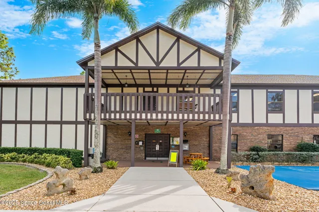 a front view of a house with garden and patio