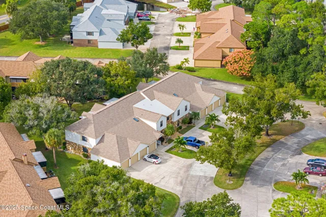 an aerial view of a house with a yard