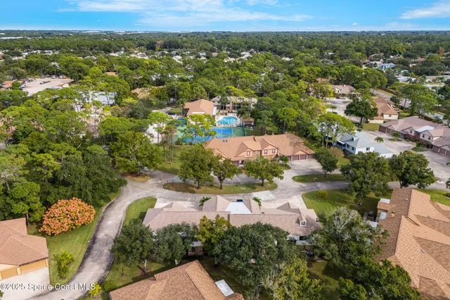 an aerial view of residential houses with outdoor space