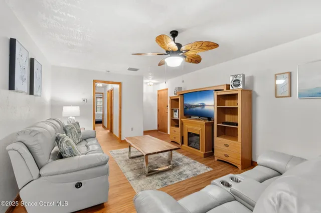 a living room with furniture and kitchen view