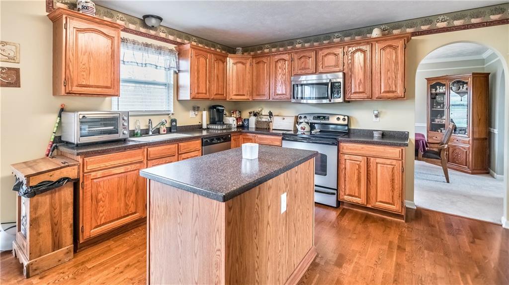 149 Riemer Road Sarver, PA 16055 - Photo 7 of 24 The kitchen has hardwood floors, a beautiful island for prep, sizeable cabinets and stainless steel appliances.