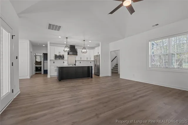 a kitchen with stainless steel appliances a table chairs and chandelier