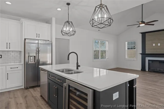 a bathroom with a double vanity sink a mirror a bathtub and shower