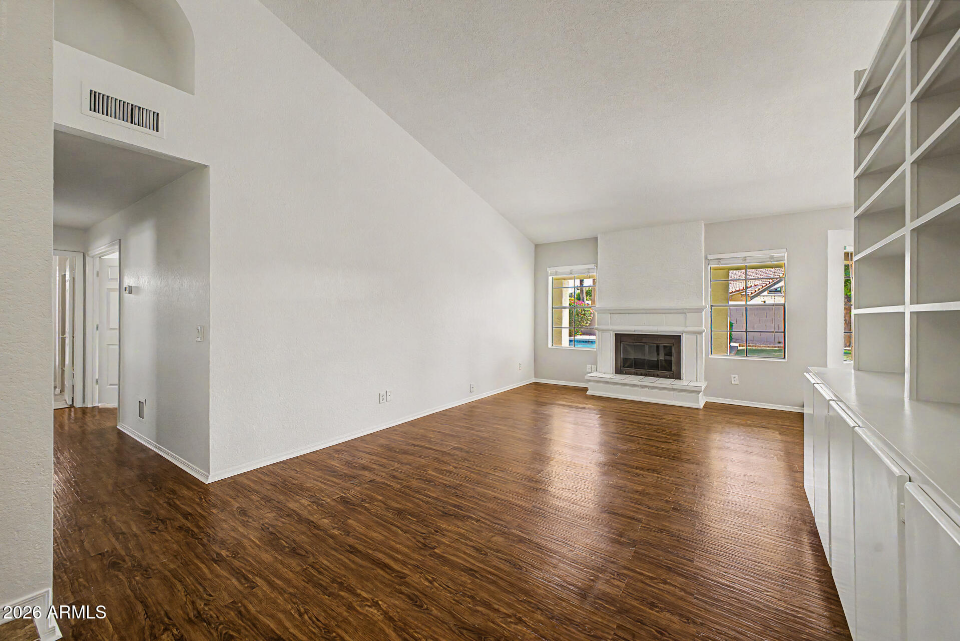6725 West Utopia Road Glendale, AZ 85308 - Photo 7 of 27 a view of empty room with wooden floor and fireplace