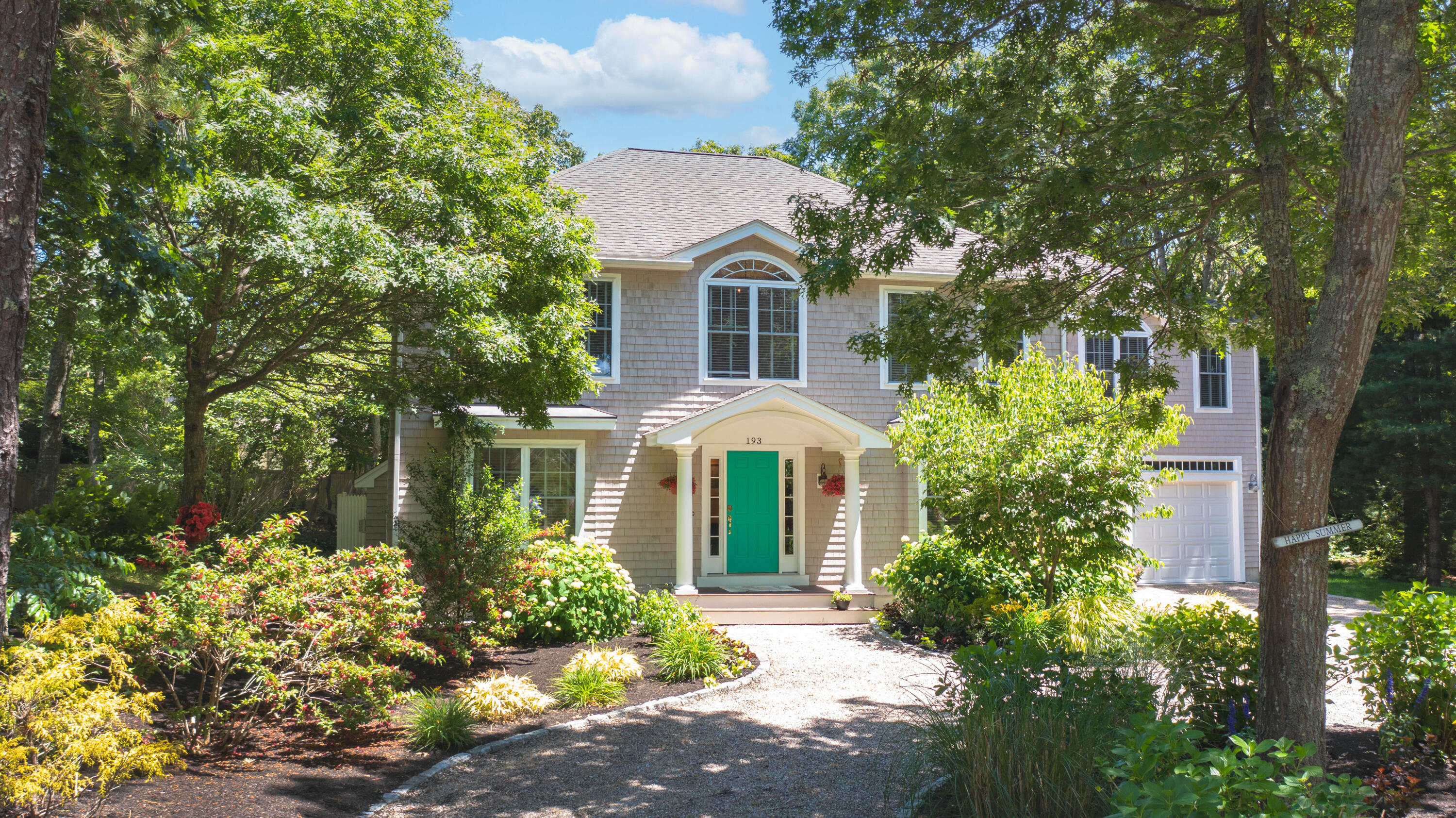a front view of a house with a yard and fountain