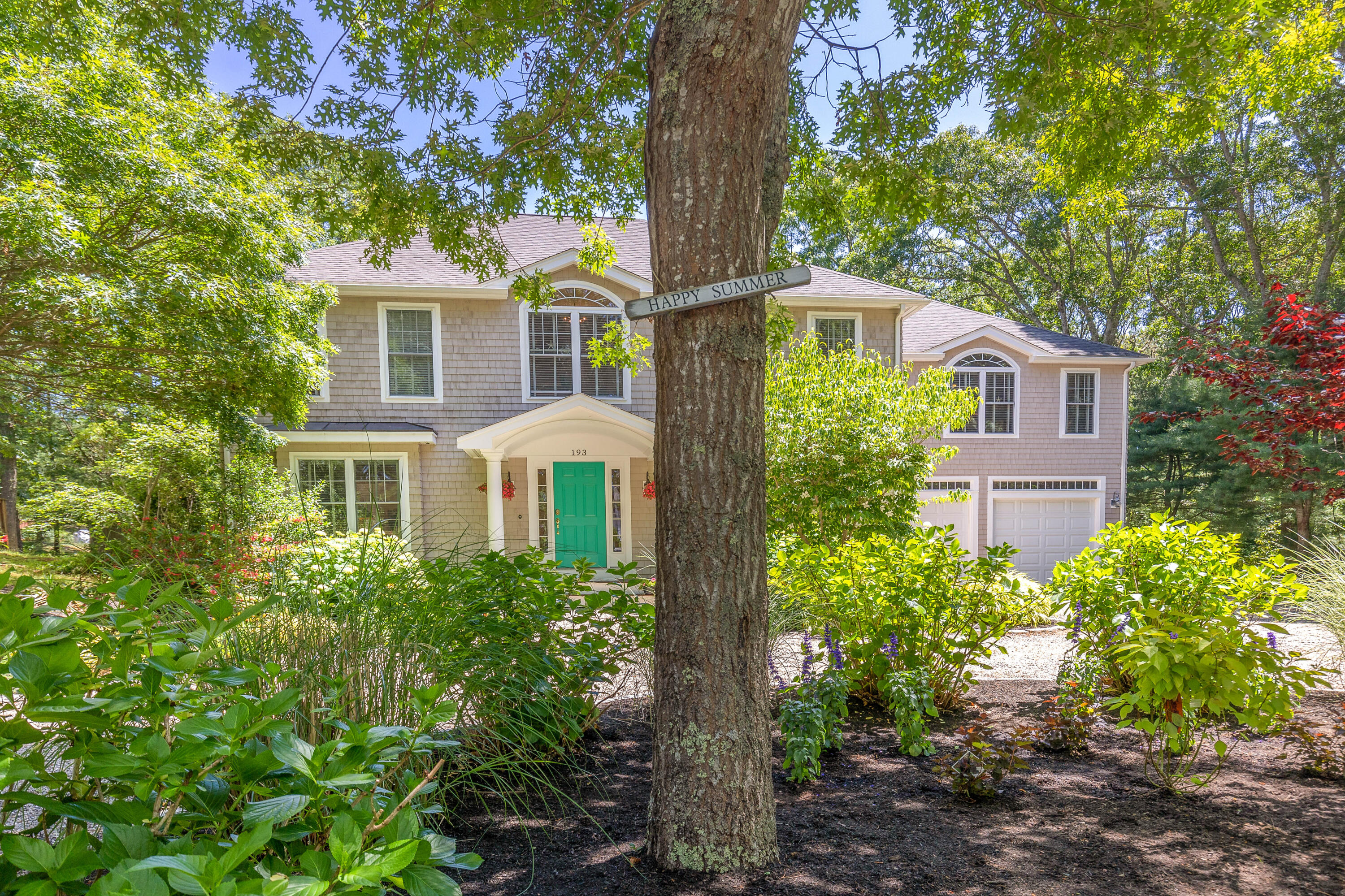 193 Fells Pond Road Mashpee, MA 02649 - Photo 2 of 33 a front view of a house with a yard and trees