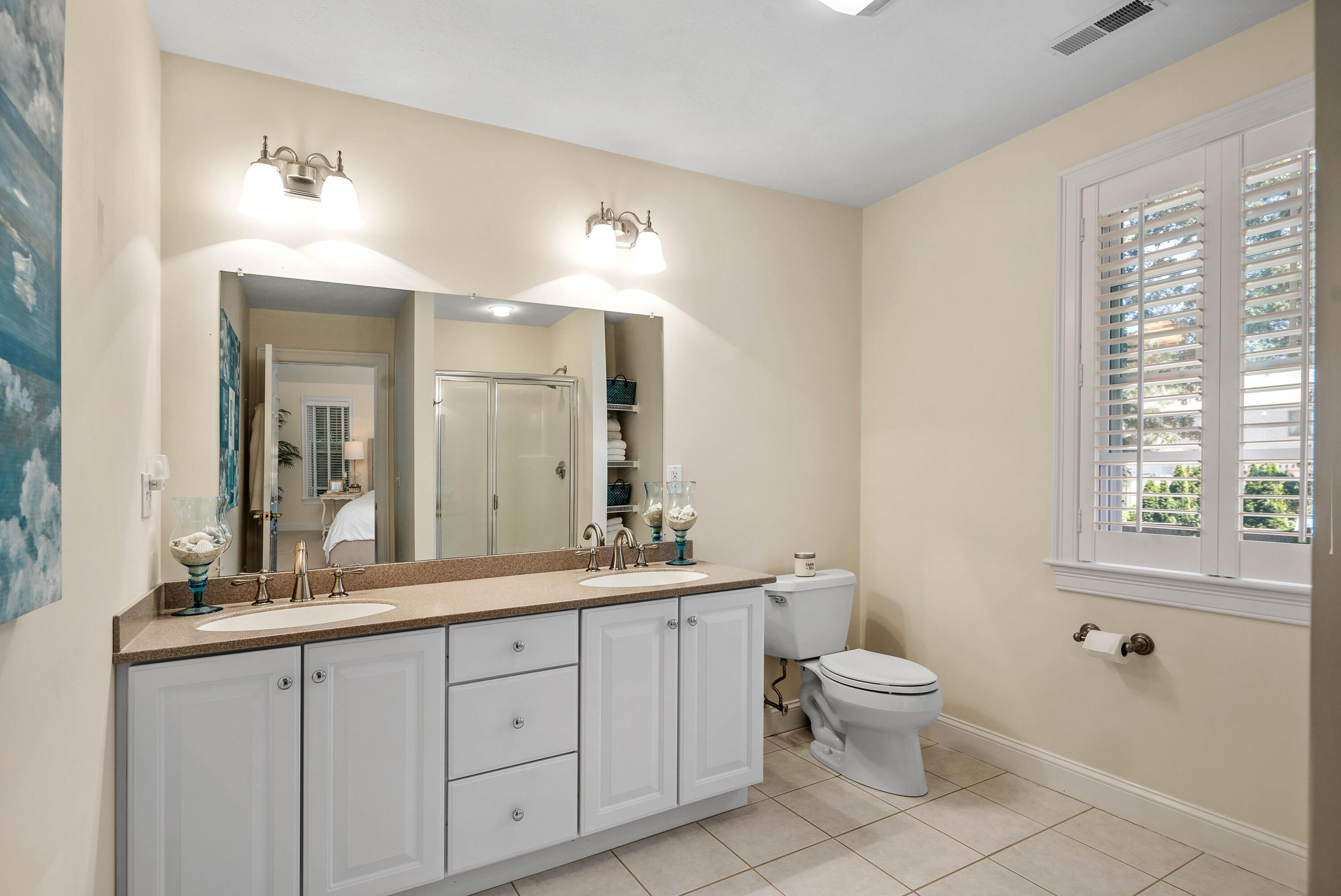 193 Fells Pond Road Mashpee, MA 02649 - Photo 24 of 33 a spacious bathroom with a double vanity sink a toilet and a mirror