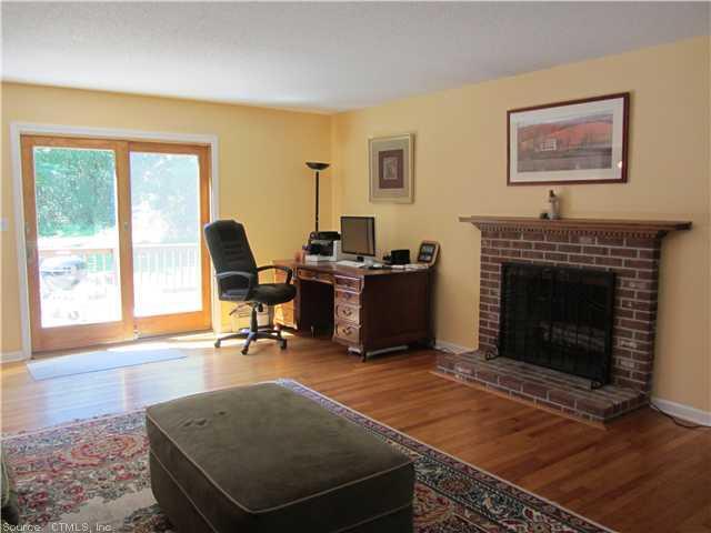 a living room with furniture a fireplace and a large window