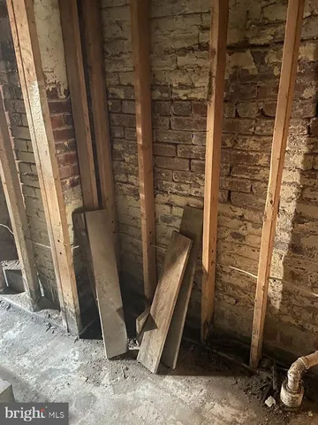 a living room with furniture a fireplace and a wooden floor