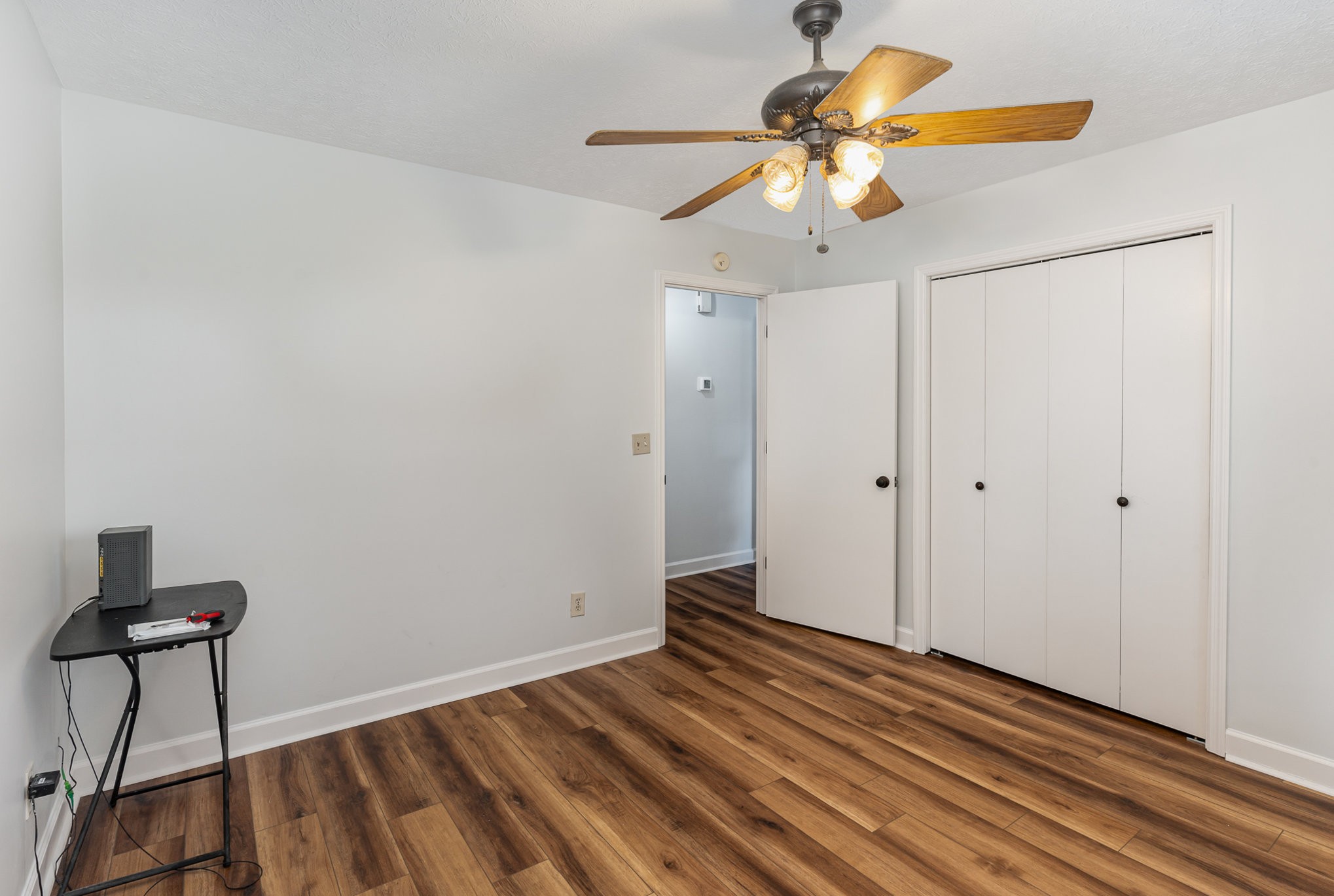 3831 Armstrong Road Springfield, TN 37172 - Photo 20 of 30 a view of an empty room with a chandelier fan and wooden floor