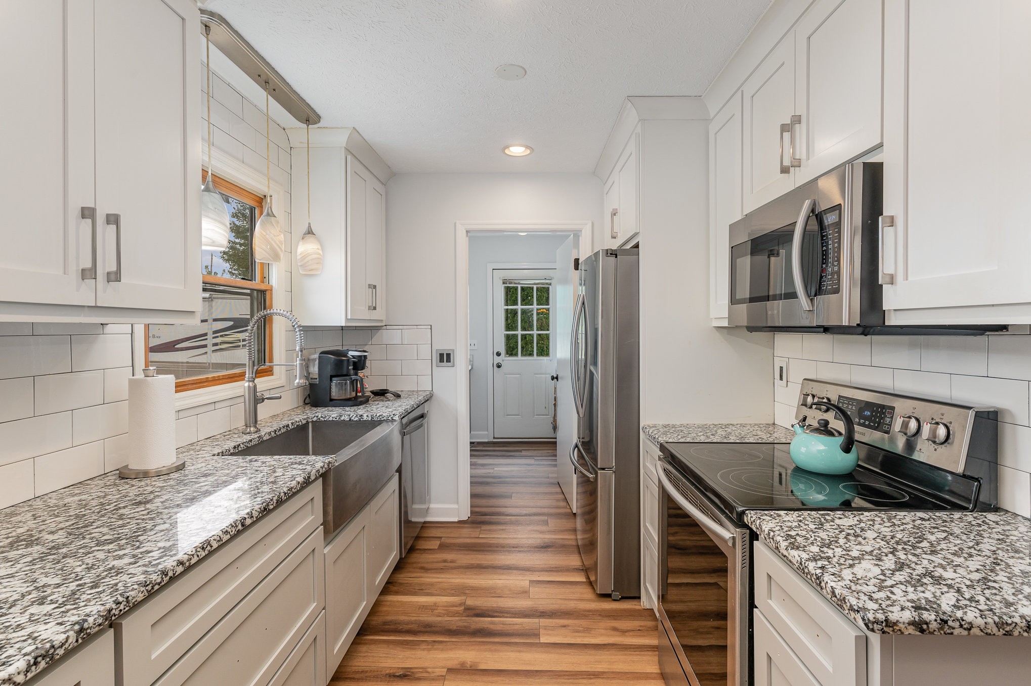 3831 Armstrong Road Springfield, TN 37172 - Photo 10 of 30 a kitchen with stainless steel appliances granite countertop a stove a sink and a microwave