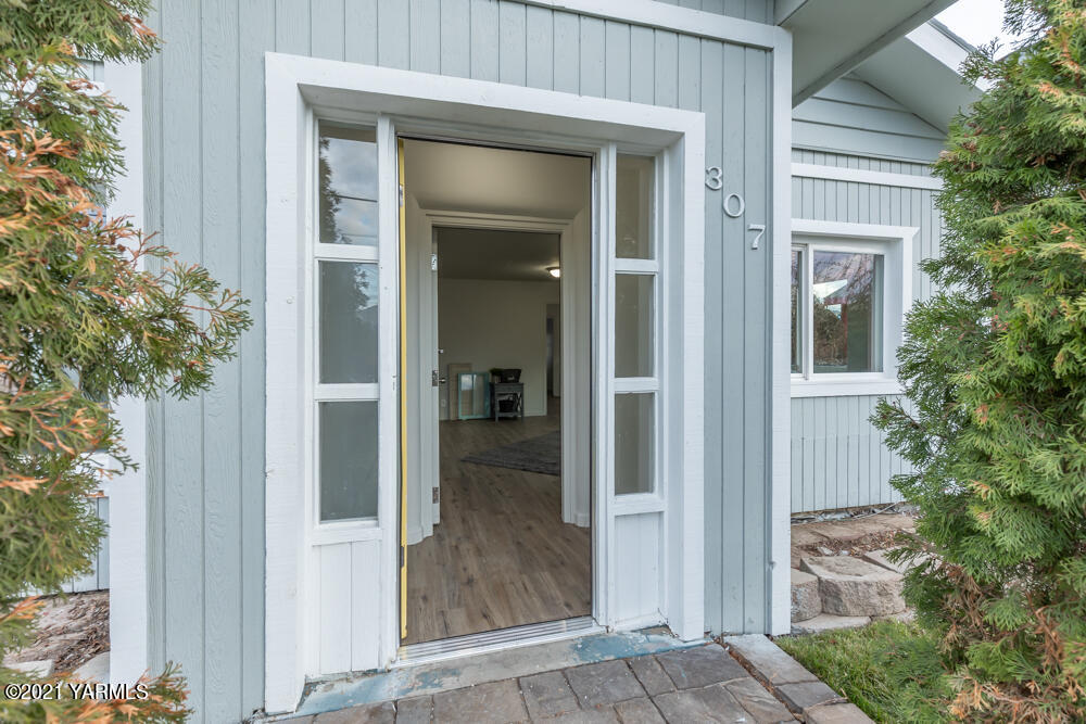 307 Nealy Road Grandview, WA 98930 - Photo 2 of 20 front view of a house with a glass door